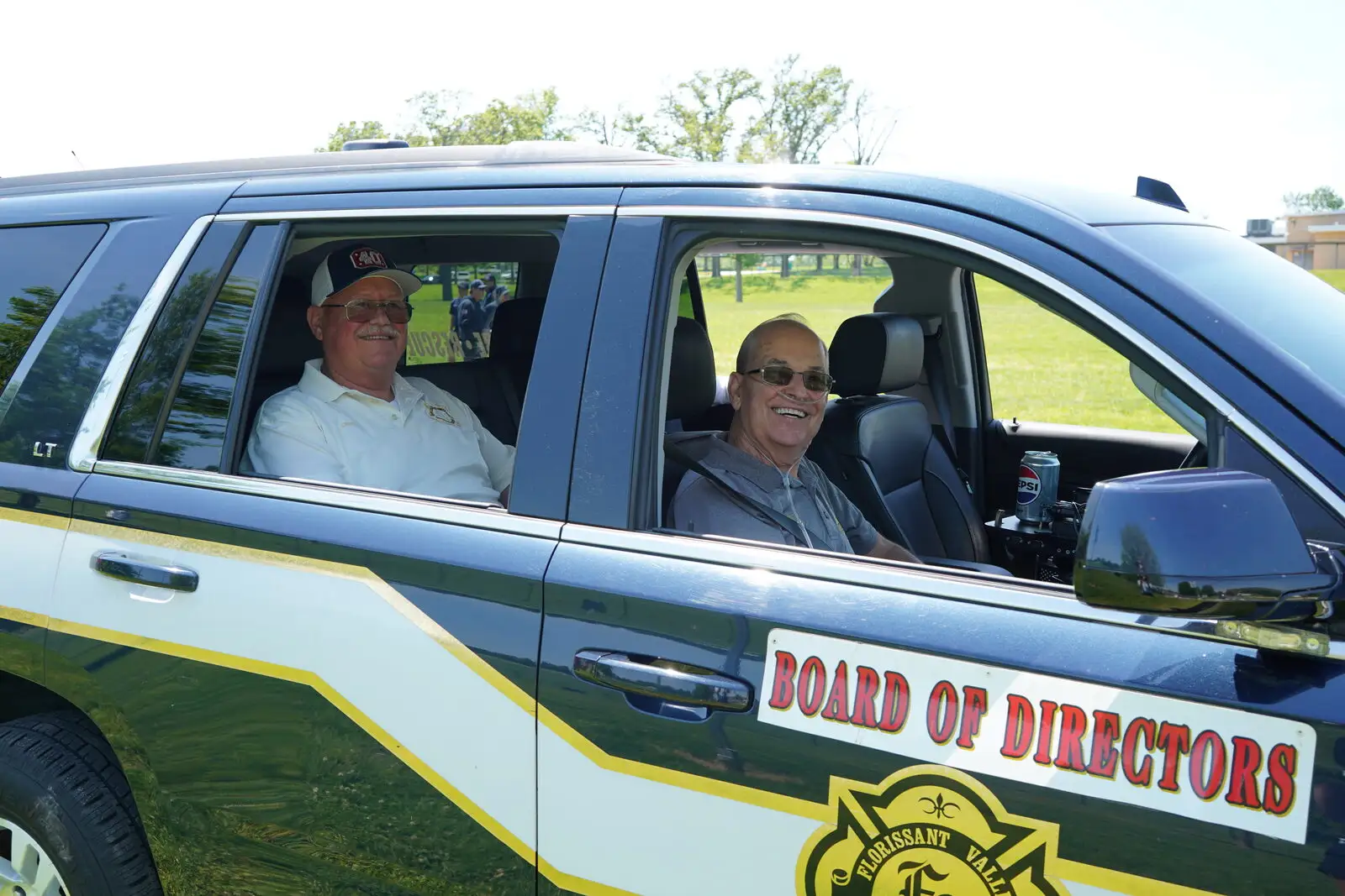 Board members riding in the District's Board of Directors vehicle at a community parade