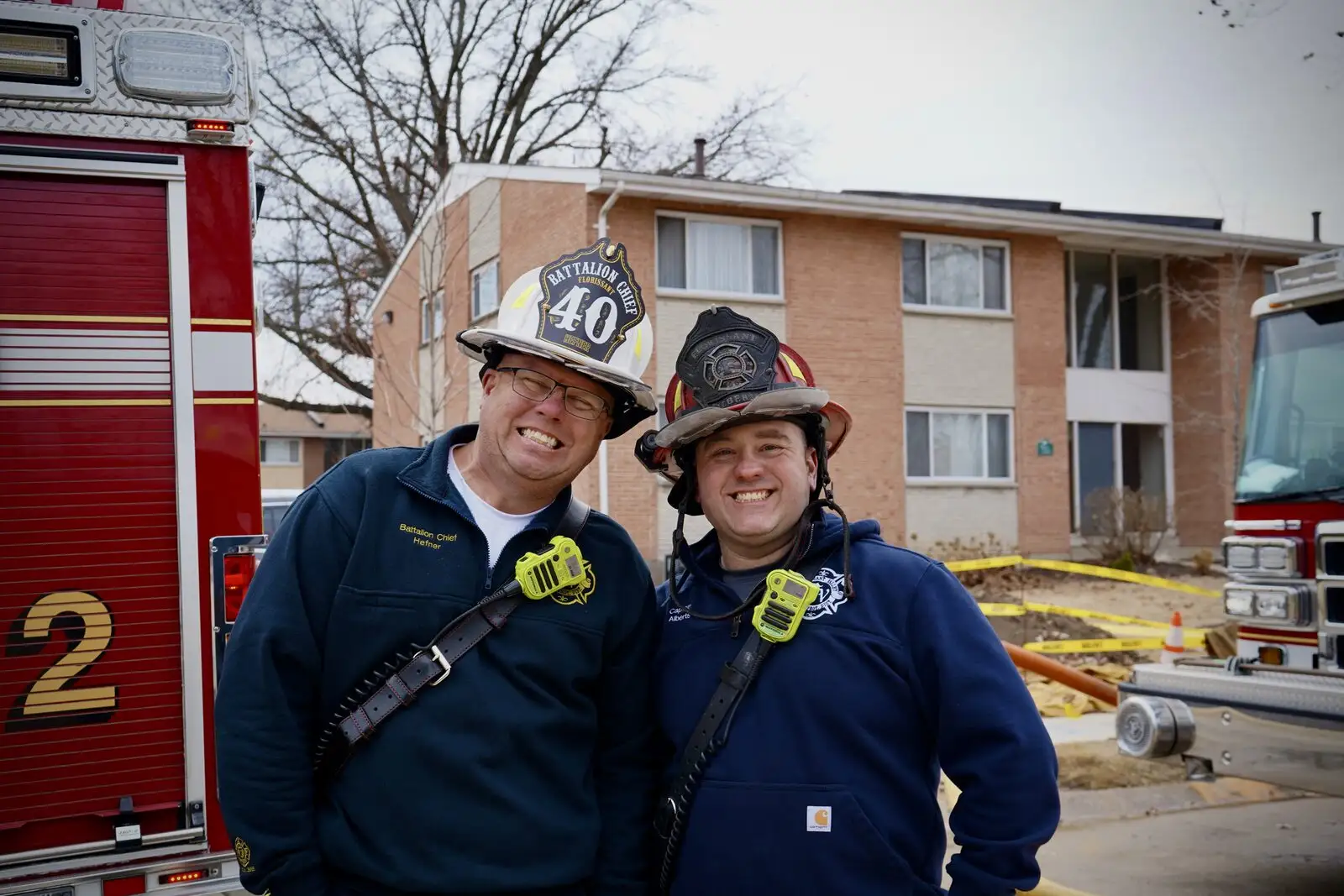Two District members share a light moment on scene