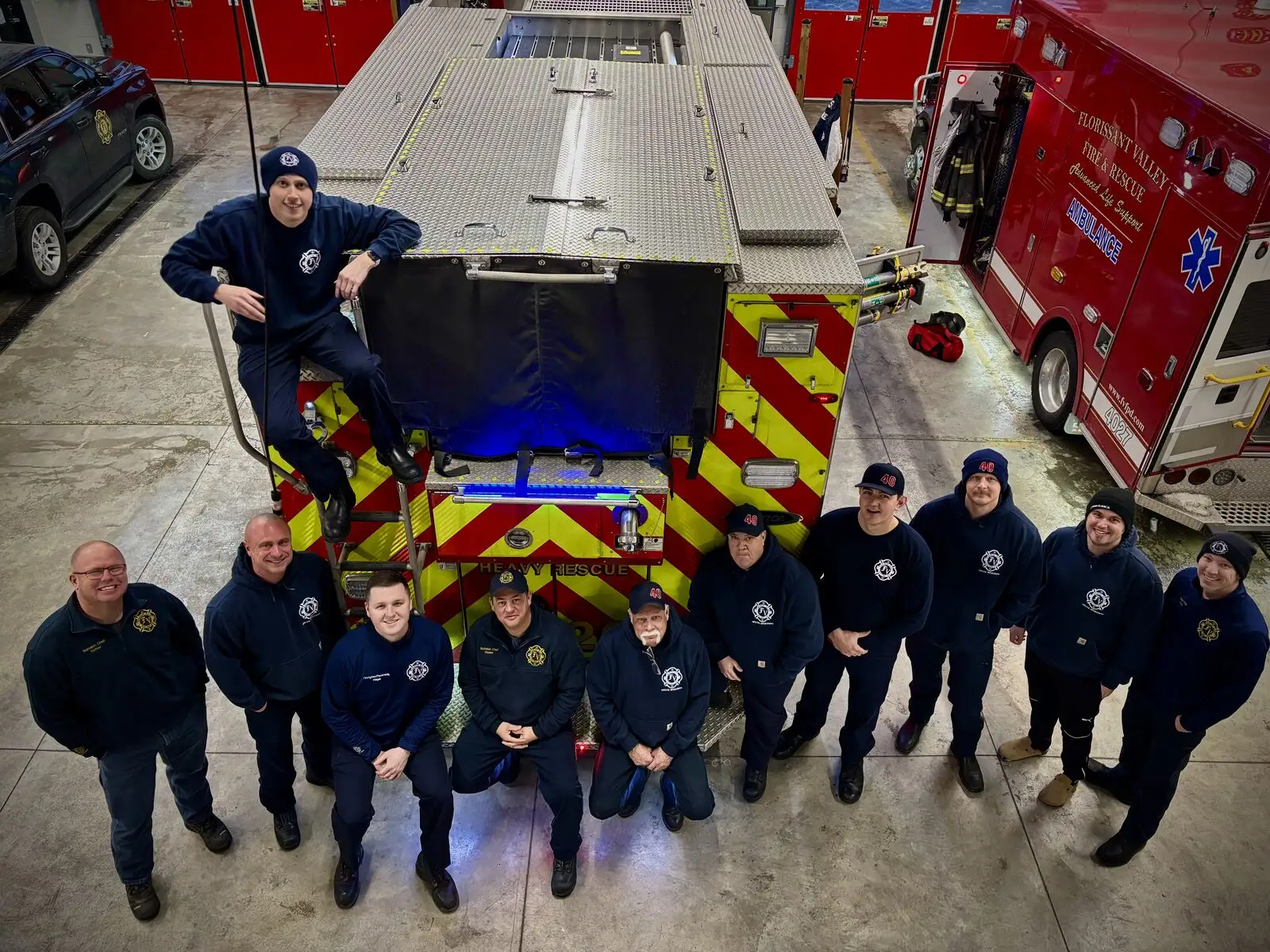 A District crew gathered around the heavy rescue in the apparatus bay