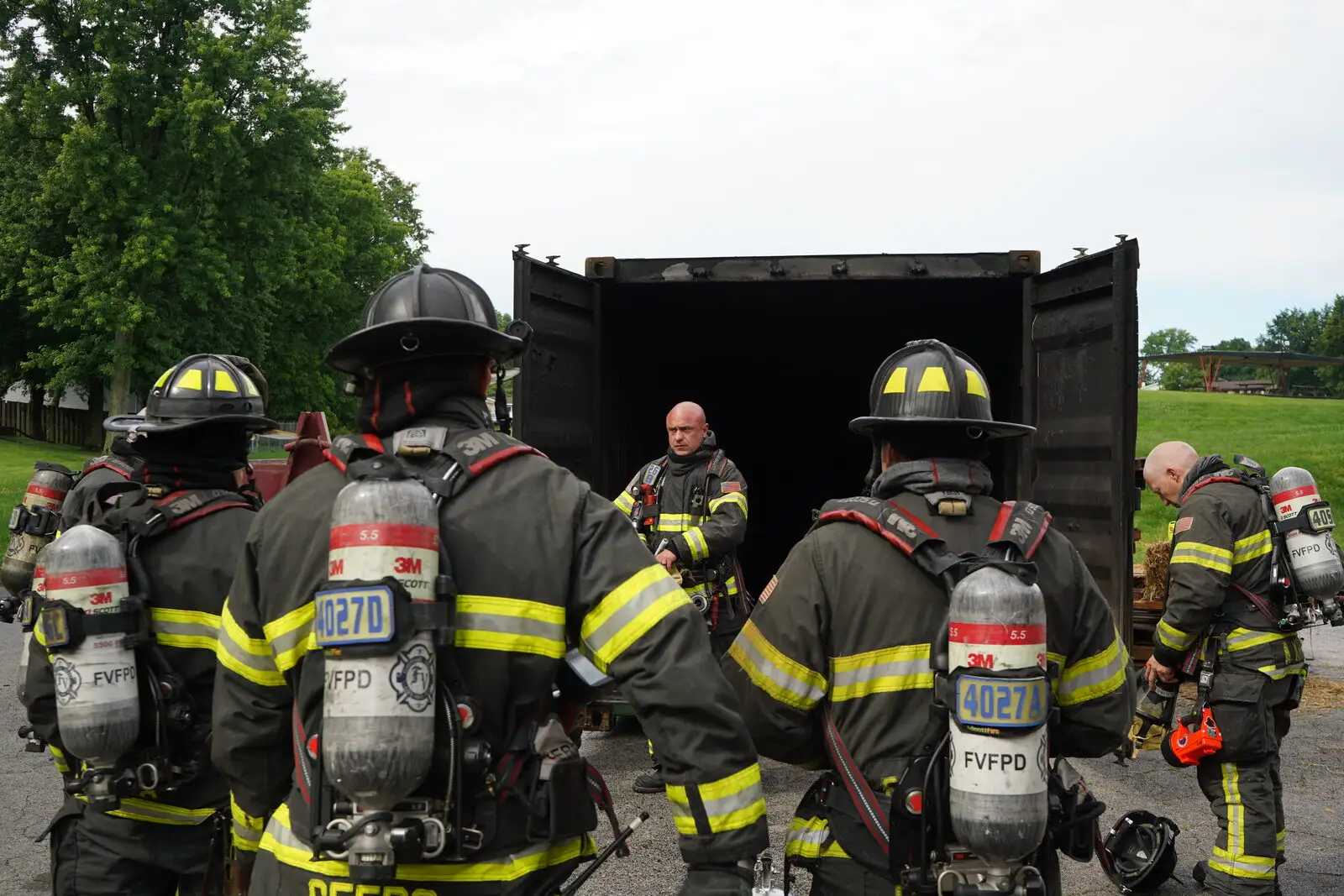 A crew works at the burn container during live-fire training