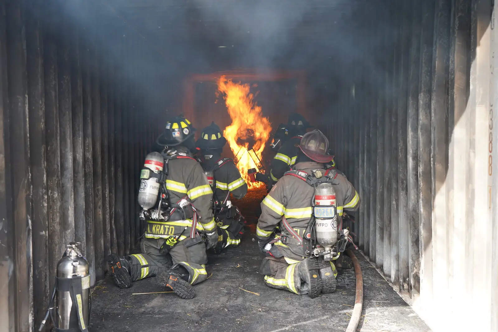 Firefighters make an interior attack during a live-fire training burn