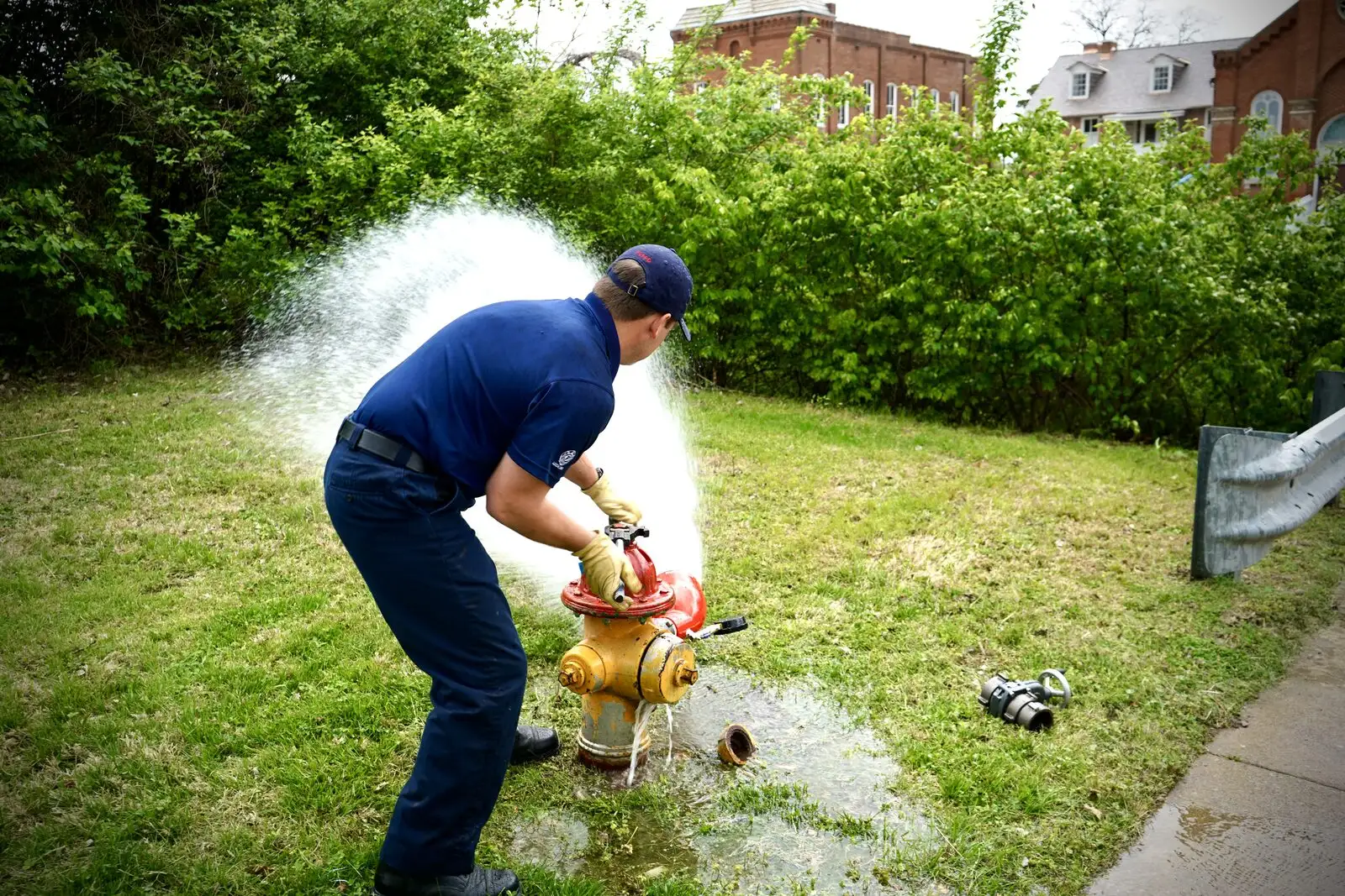 A firefighter flushes a fire hydrant to check the water supply
