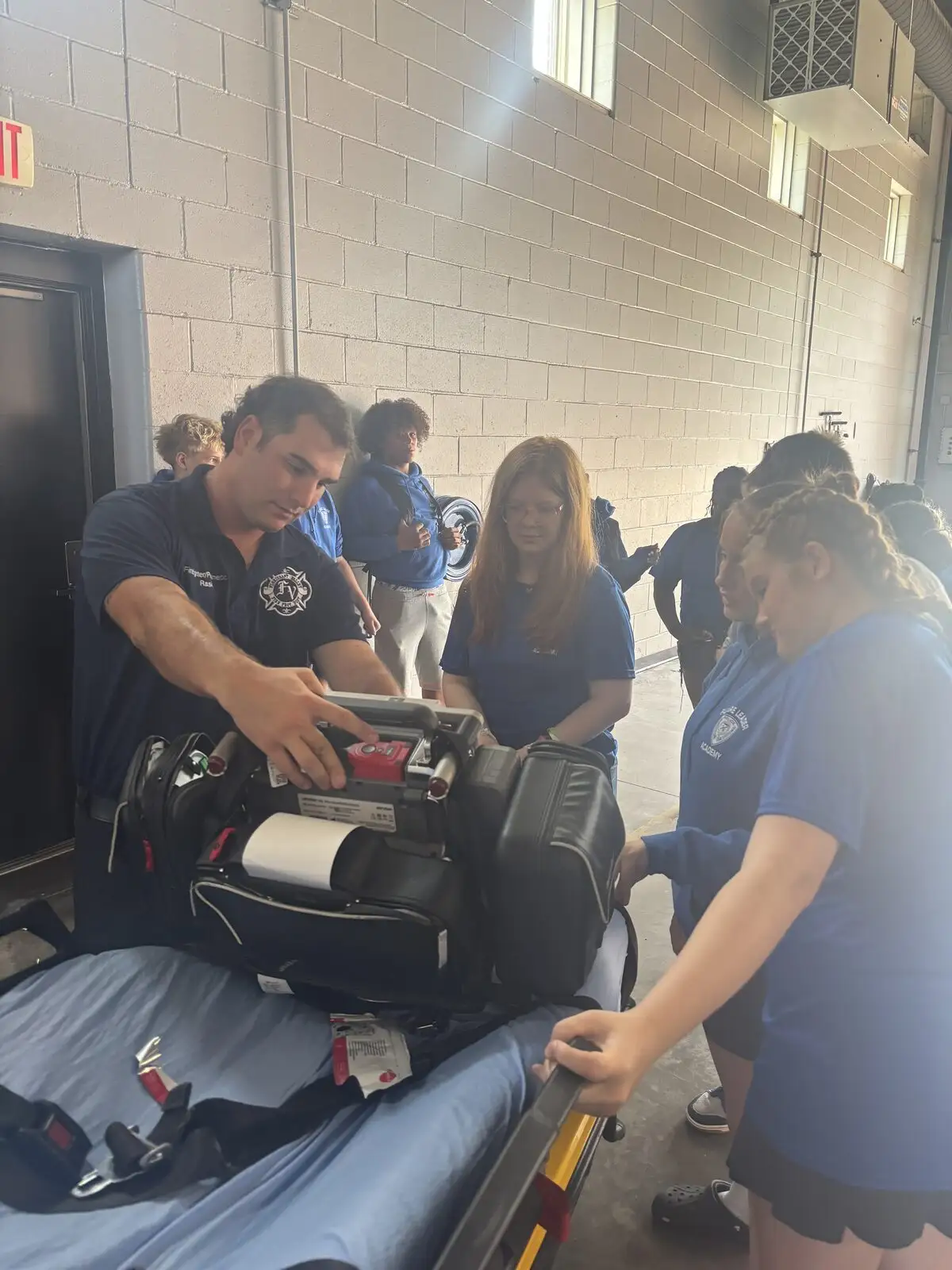 A firefighter/paramedic teaching EMS skills at a youth academy