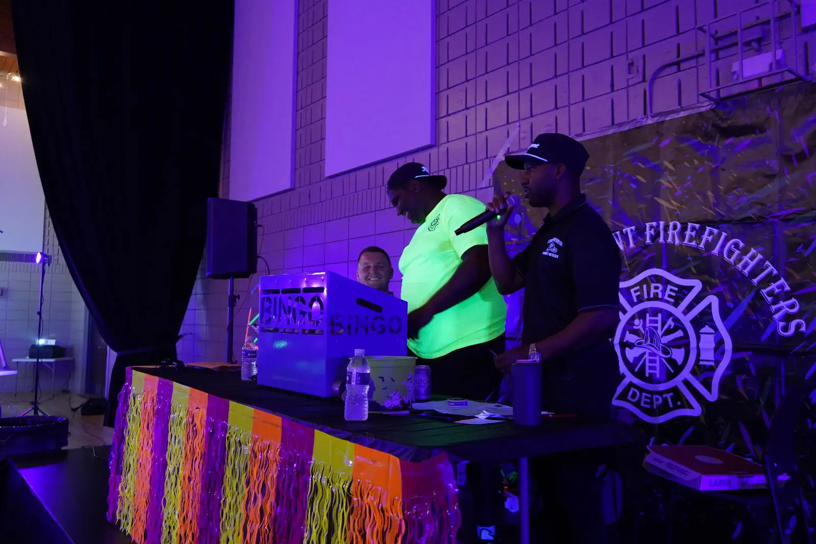 Firefighters calling numbers at the Black Light Bingo Bash