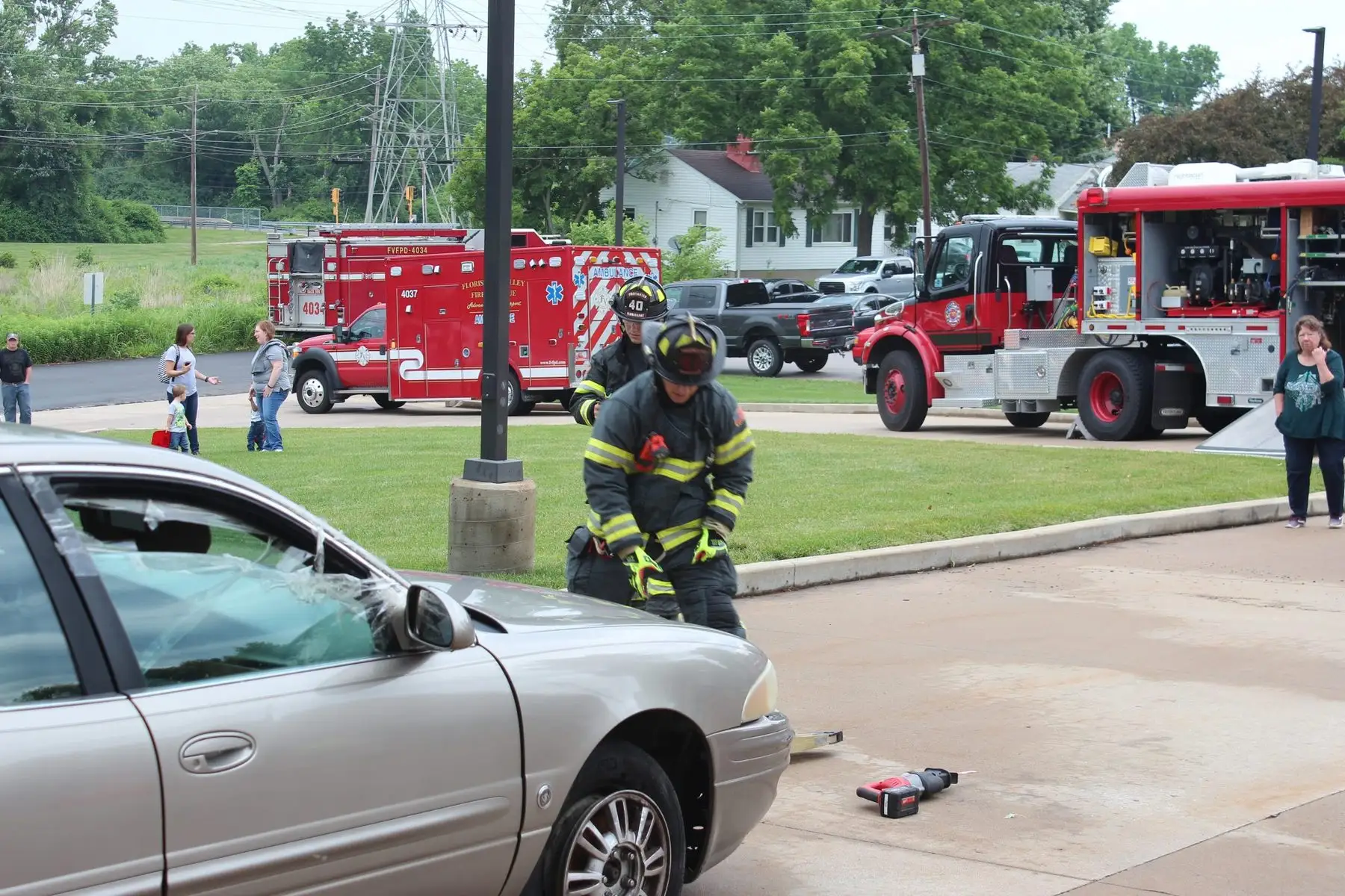 Firefighters running a vehicle-extrication demonstration for the public at a firehouse open house