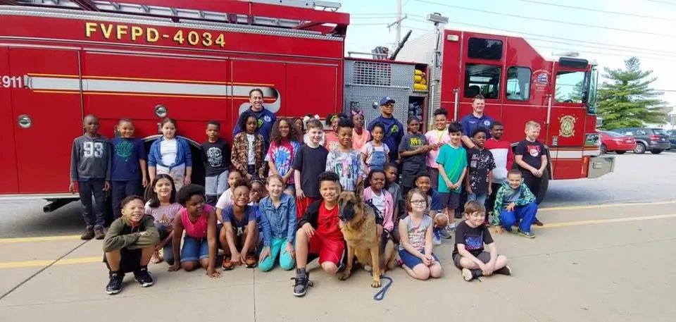 Children gathered in front of a District fire truck