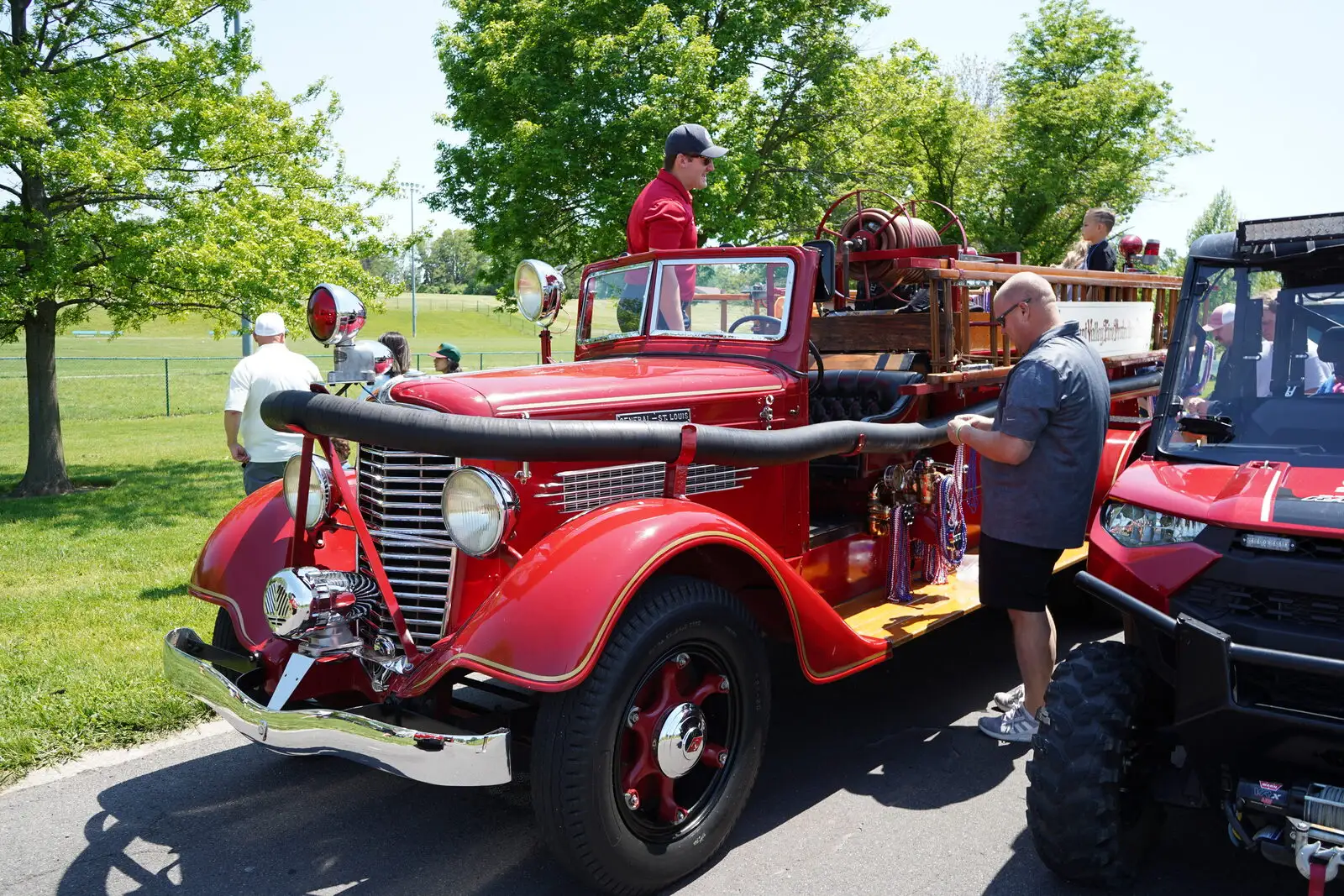 A restored vintage fire engine on display at a community event