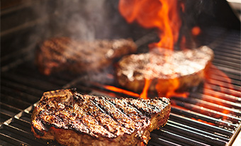 Flaming grill with steaks